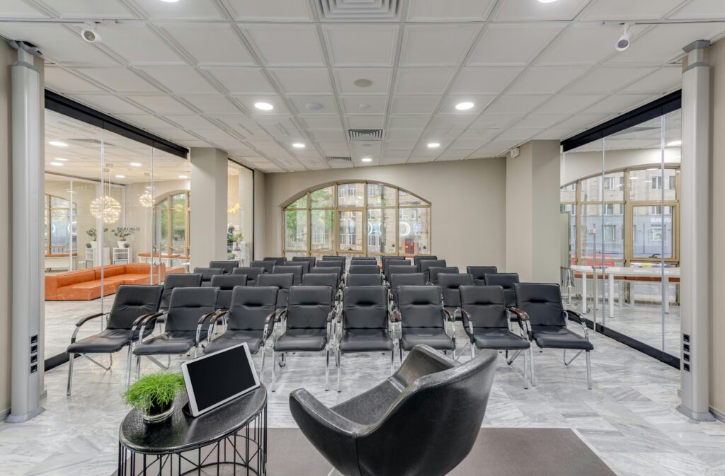 Spacious conference room with modern seating and glass walls, ideal for meetings.
